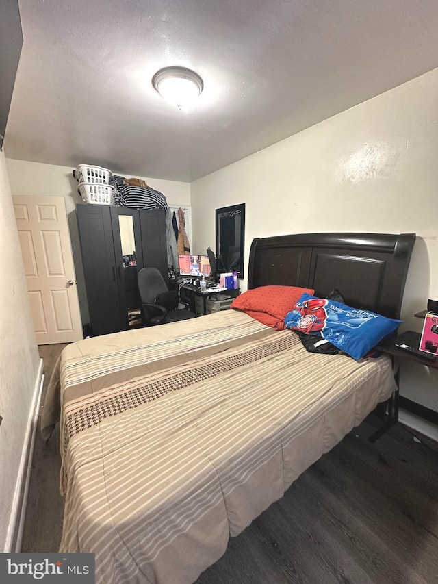 bedroom with hardwood / wood-style floors