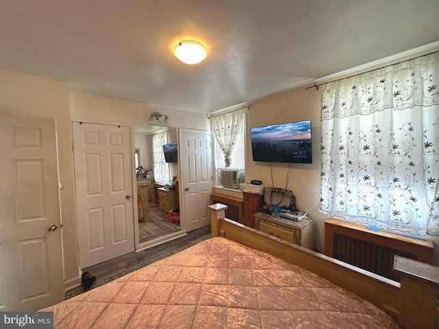 bedroom featuring radiator heating unit and connected bathroom