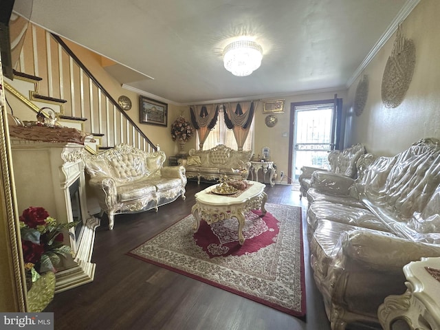 living room with ornamental molding, dark hardwood / wood-style flooring, and a notable chandelier