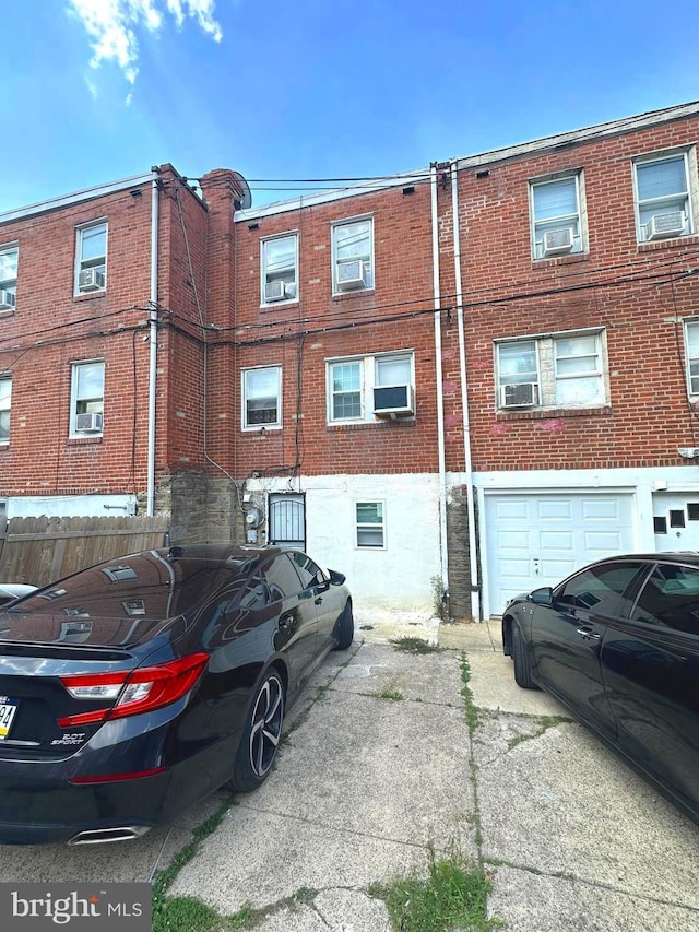 view of building exterior featuring cooling unit and a garage