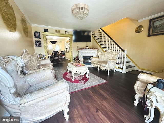 living room with hardwood / wood-style flooring and crown molding