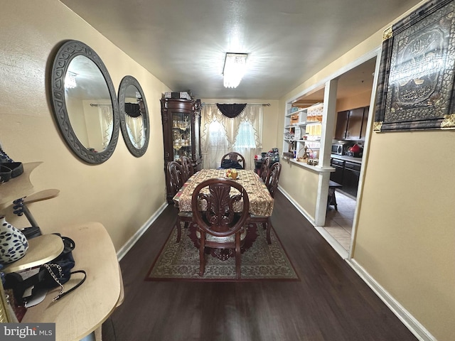 dining area with dark hardwood / wood-style flooring