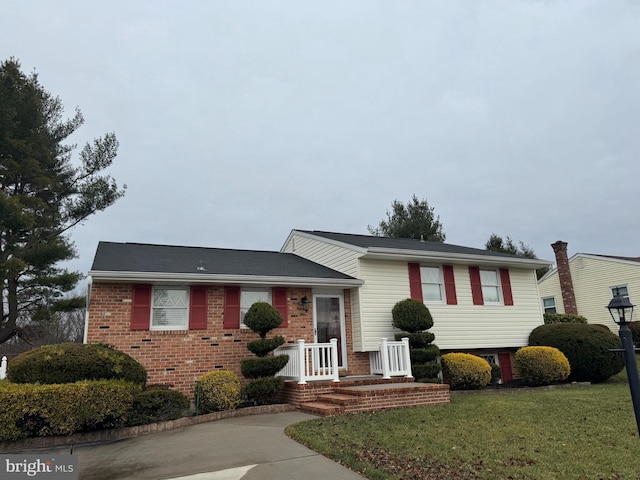 tri-level home with a front yard