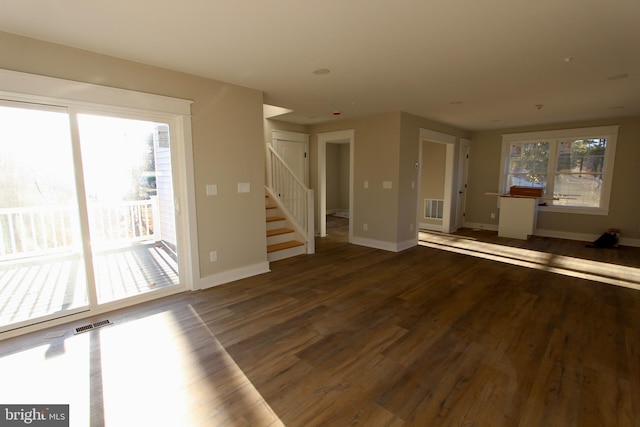 unfurnished living room featuring dark wood-type flooring