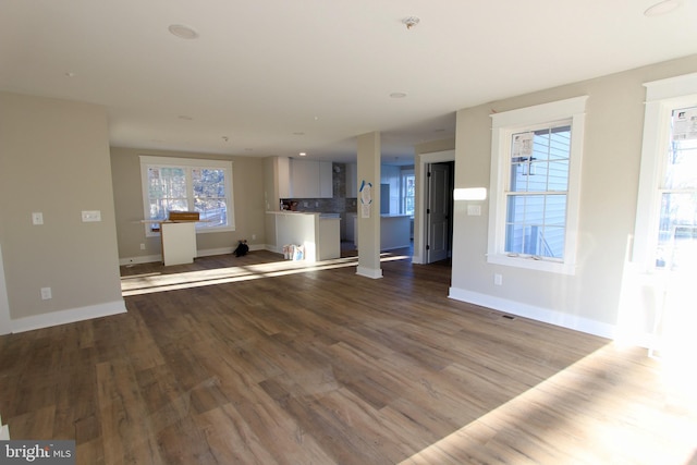 unfurnished living room with hardwood / wood-style flooring