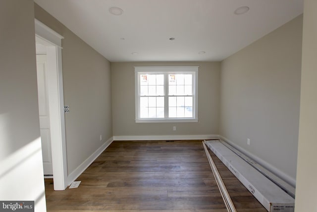 empty room featuring dark hardwood / wood-style flooring