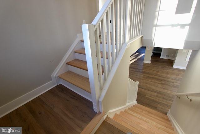 stairway featuring hardwood / wood-style flooring