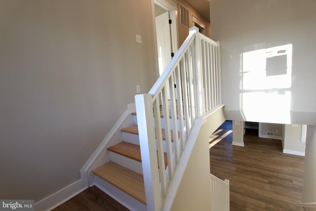 stairs featuring wood-type flooring