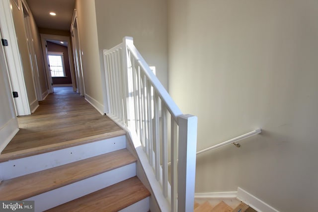 stairway featuring hardwood / wood-style flooring