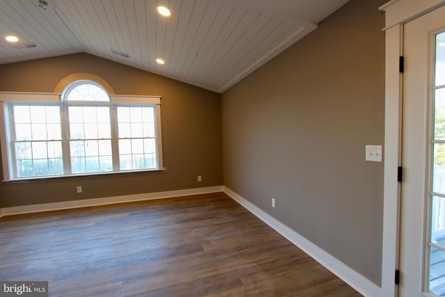 empty room featuring dark hardwood / wood-style flooring, wooden ceiling, and lofted ceiling