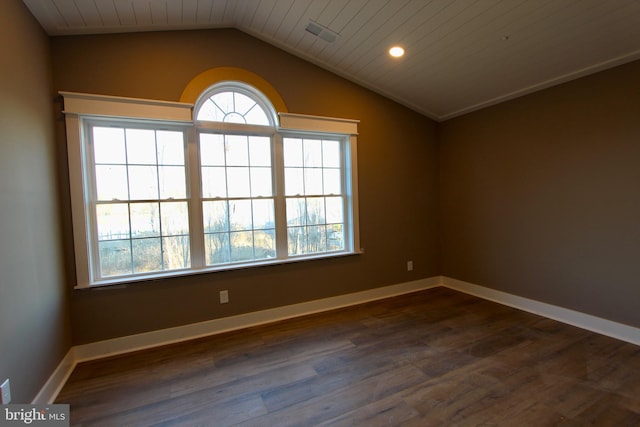 unfurnished room featuring dark hardwood / wood-style floors and vaulted ceiling