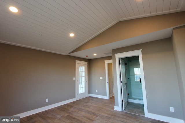 empty room featuring hardwood / wood-style floors, lofted ceiling, and wood ceiling