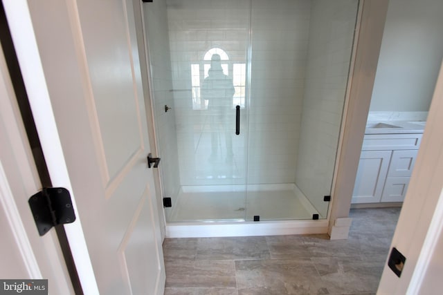 bathroom featuring a shower with door