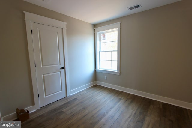 empty room featuring dark hardwood / wood-style flooring