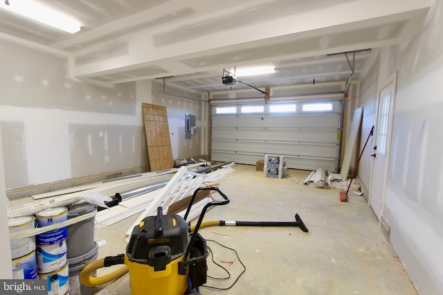 garage with electric panel and a garage door opener