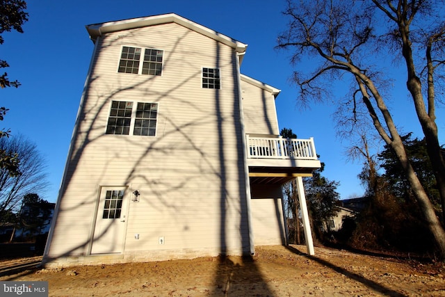 back of property with a balcony