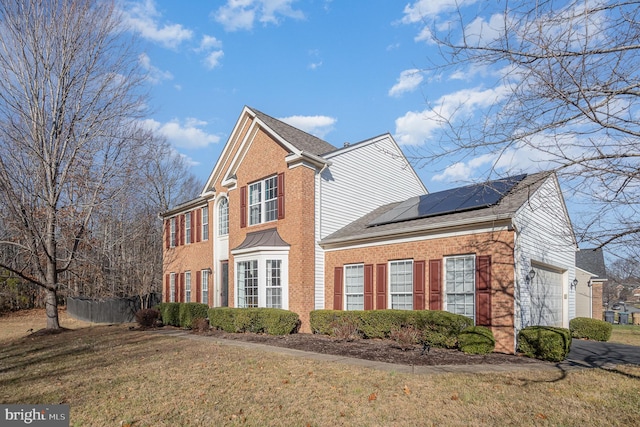 view of home's exterior featuring solar panels, a yard, and a garage