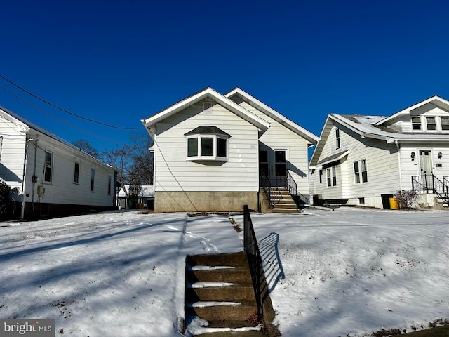 view of snow covered rear of property