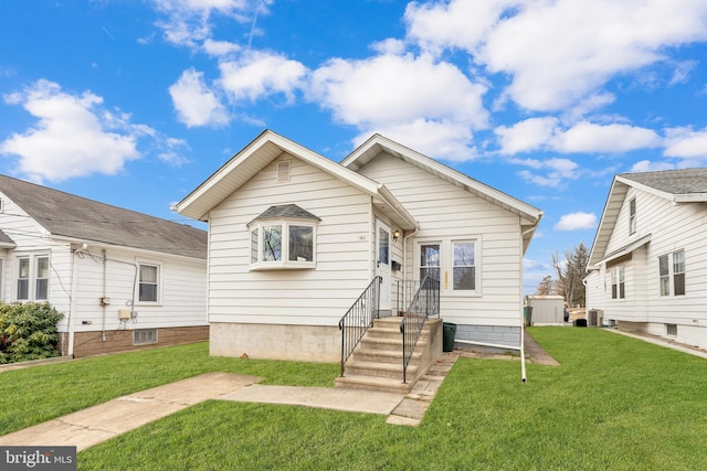 bungalow featuring central AC and a front yard