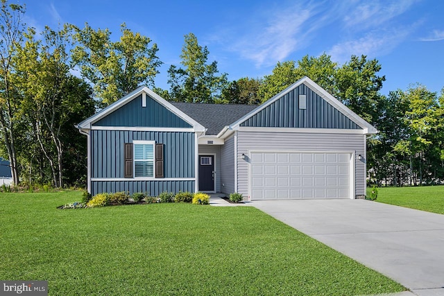 view of front of home with a front yard and a garage