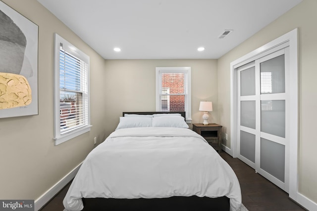 bedroom with dark wood-type flooring