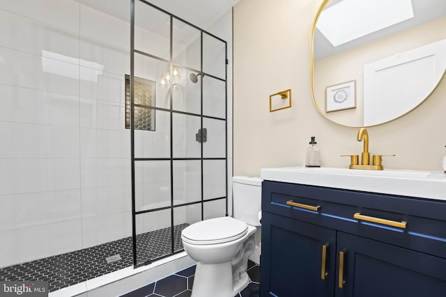 bathroom with a tile shower, a skylight, tile patterned flooring, toilet, and vanity