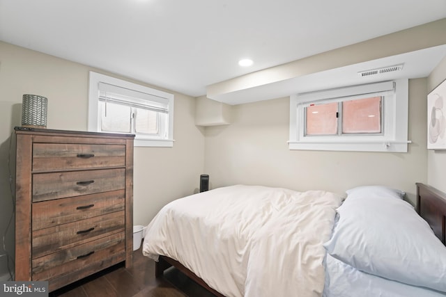 bedroom with dark hardwood / wood-style flooring