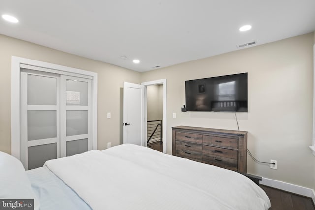 bedroom with dark hardwood / wood-style flooring