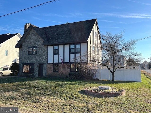 view of side of home with a lawn