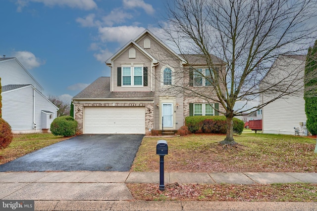 view of front of home featuring a front yard and a garage