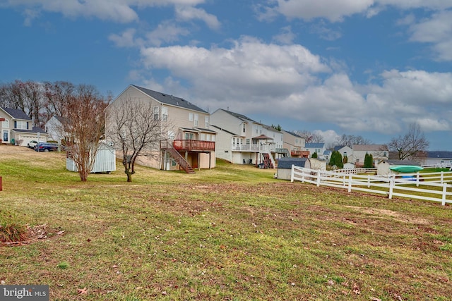 view of yard with a wooden deck and a shed