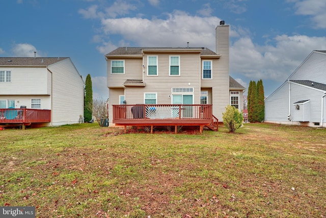 rear view of property with a lawn, cooling unit, and a wooden deck