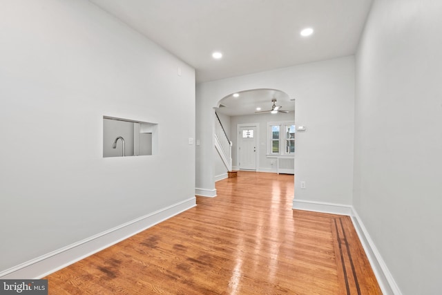 corridor featuring light hardwood / wood-style floors and radiator