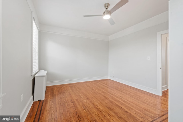 empty room with hardwood / wood-style flooring and ceiling fan