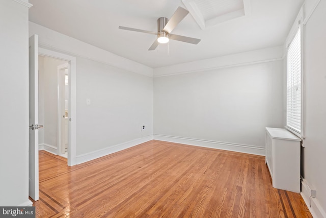 empty room featuring hardwood / wood-style floors, ceiling fan, and a healthy amount of sunlight