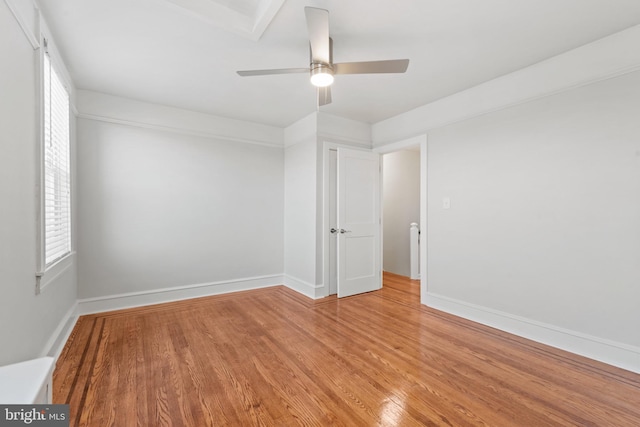 empty room featuring light wood-type flooring and ceiling fan