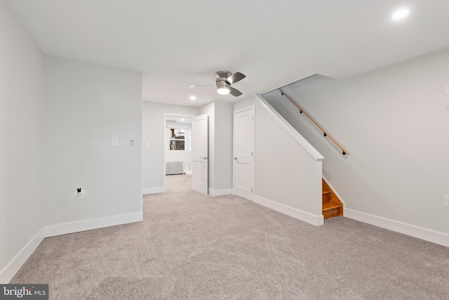 unfurnished living room featuring ceiling fan and light colored carpet