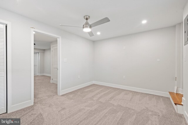 carpeted empty room featuring ceiling fan