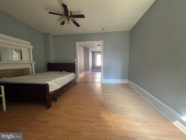 bedroom with ceiling fan and light wood-type flooring