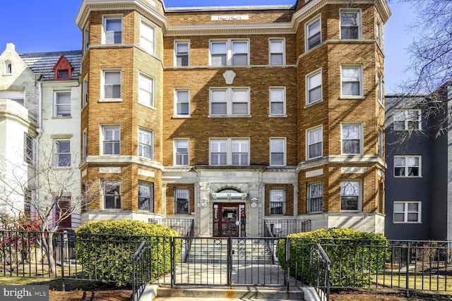 view of building exterior with a fenced front yard