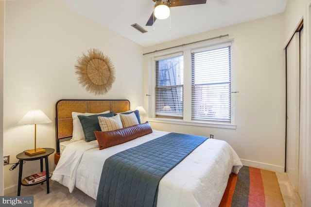 bedroom featuring baseboards, visible vents, ceiling fan, and a closet