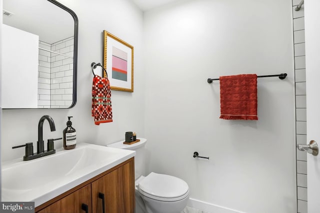 bathroom with visible vents, vanity, and toilet