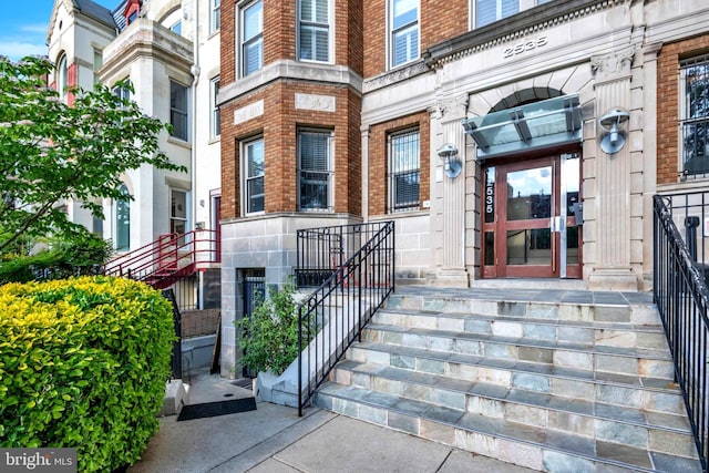 property entrance with brick siding