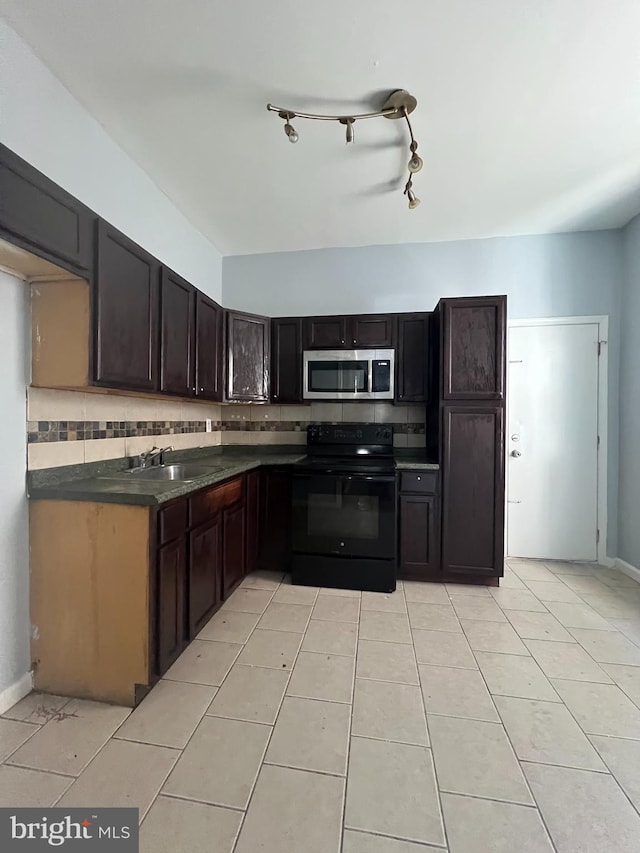 kitchen featuring backsplash, sink, light tile patterned floors, black / electric stove, and dark brown cabinetry