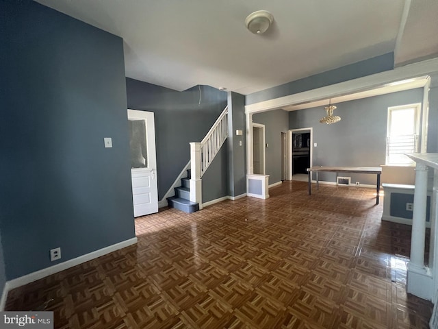 unfurnished living room featuring dark parquet floors