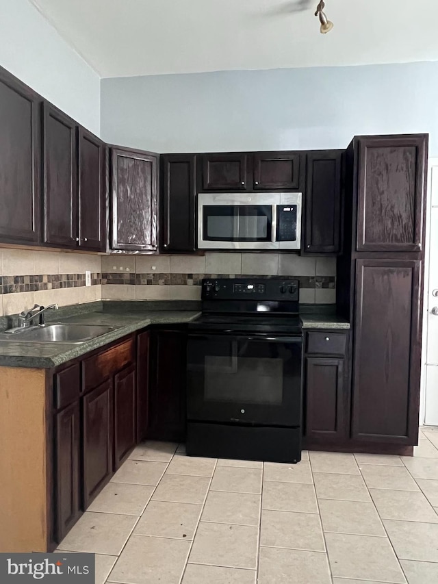 kitchen featuring backsplash, sink, and black electric range