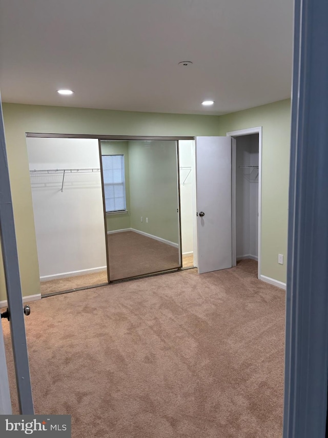 unfurnished bedroom featuring light colored carpet