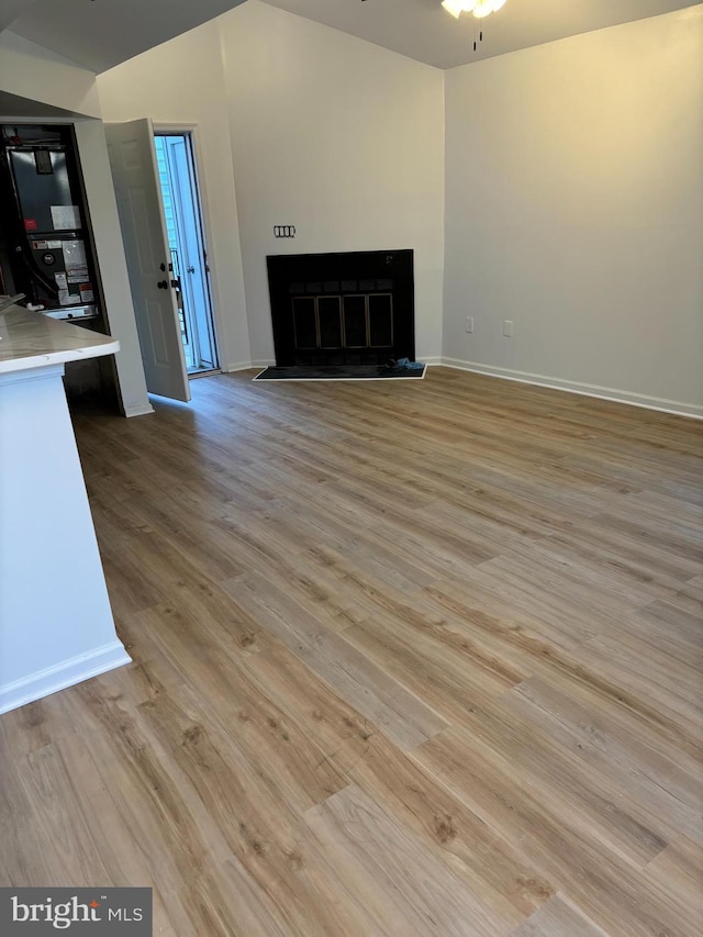 unfurnished living room featuring ceiling fan and light wood-type flooring