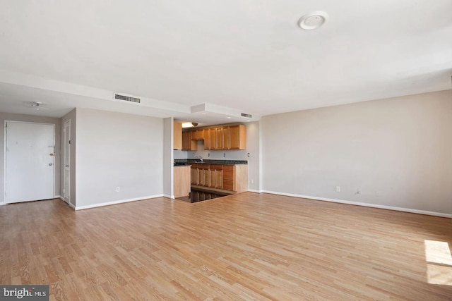 unfurnished living room featuring light wood-type flooring