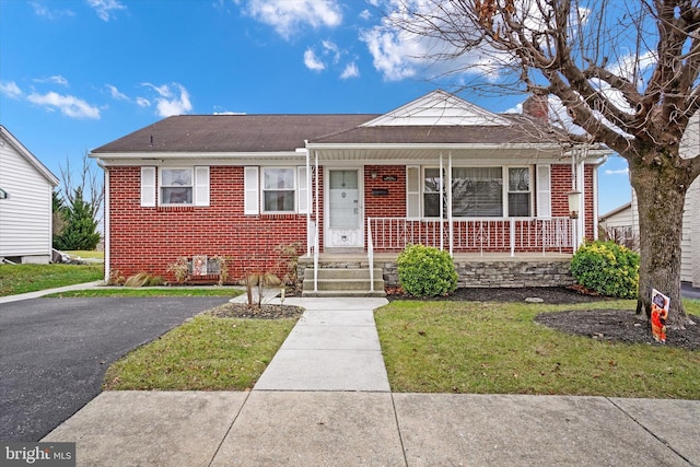 bungalow-style home featuring a front yard